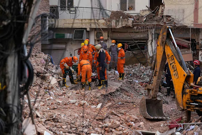 Rescuers search for people trapped in a New Delhi building collapse as death toll rises to 6