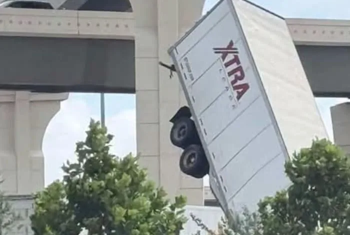 18-wheeler left hanging over I-10 overpass after crash near SH-99