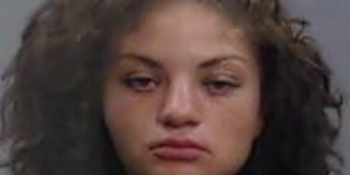 Woman arrested after man says she pinned him between vehicles