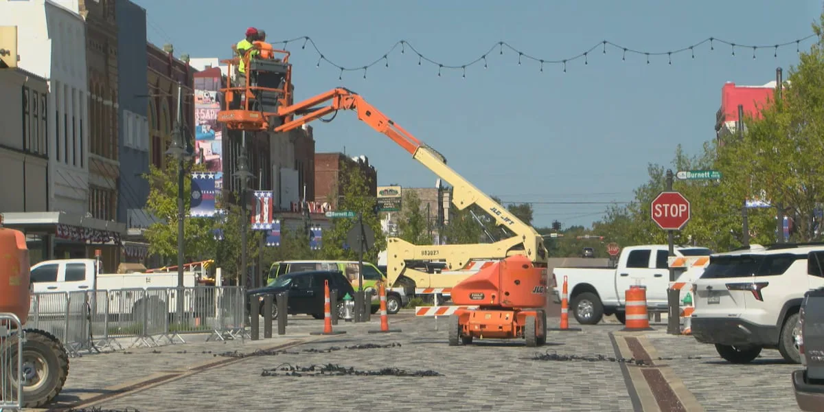 Crews hang new festive lights in downtown Denison