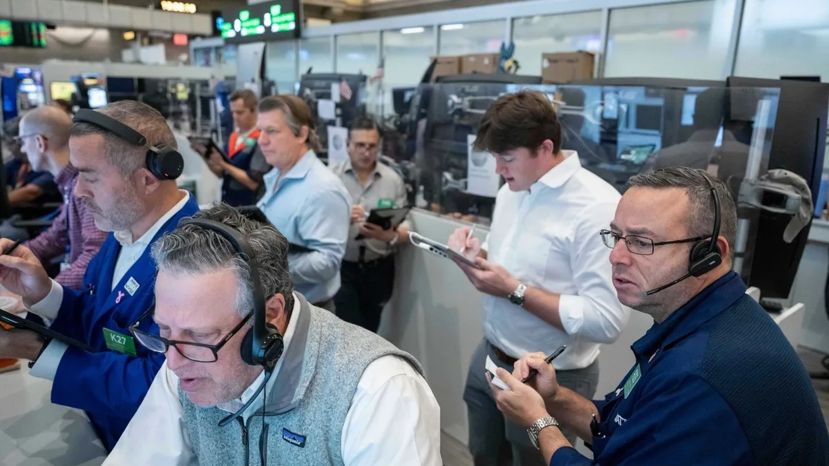 US stocks hover near their latest record in mixed trading on Wall Street