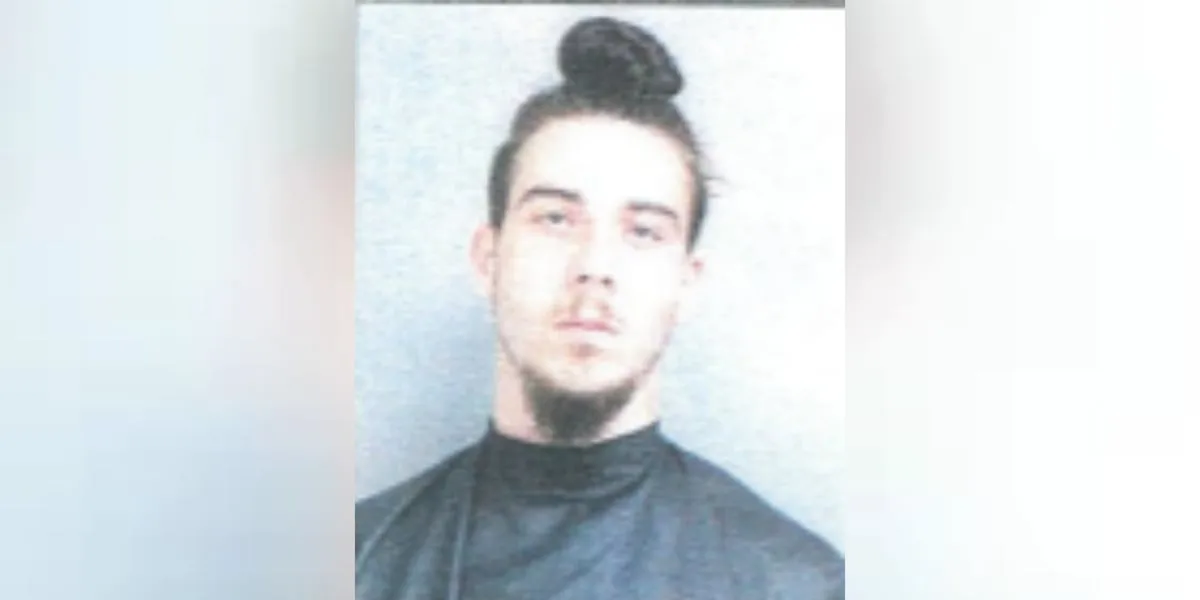 Man arrested for sitting on roof of elementary school with knife, warrants show