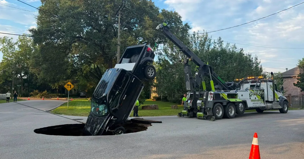 Pickup truck swallowed by road collapse following major water main break in Beaumont